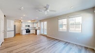 Located in Mountain House, CA, this two-story home offers 3 bedrooms and 5 bathrooms across two well-proportioned floors. The ground floor hosts an open-concept kitchen and living area with light wood-look flooring, recessed lighting, and a ceiling fan that fills the space with a bright, airy feel. The kitchen is outfitted with white shaker cabinetry, dark countertops, a classic subway tile backsplash, and a full suite of stainless steel appliances including a French door refrigerator, electric range with over-the-range microwave, and dishwasher. An attached garage with an automatic opener provides convenient interior access. Upstairs, the more expansive floor houses all three bedrooms, with plush carpeting throughout. The generously sized primary bedroom features two closets and is served by a private en-suite bathroom with white cabinetry, dark countertops, a walk-in shower, and wood-look tile flooring. Additional bedrooms are well-sized with carpeted floors and ample closet storage. The five bathrooms are distributed across both floors, with clean, modern finishes. Neutral tones, recessed lighting, and consistent design elements throughout lend the home a cohesive and polished aesthetic.