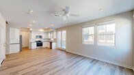 Located in Mountain House, CA, this two-story home offers 3 bedrooms and 5 bathrooms across two well-proportioned floors. The ground floor hosts an open-concept kitchen and living area with light wood-look flooring, recessed lighting, and a ceiling fan that fills the space with a bright, airy feel. The kitchen is outfitted with white shaker cabinetry, dark countertops, a classic subway tile backsplash, and a full suite of stainless steel appliances including a French door refrigerator, electric range with over-the-range microwave, and dishwasher. An attached garage with an automatic opener provides convenient interior access. Upstairs, the more expansive floor houses all three bedrooms, with plush carpeting throughout. The generously sized primary bedroom features two closets and is served by a private en-suite bathroom with white cabinetry, dark countertops, a walk-in shower, and wood-look tile flooring. Additional bedrooms are well-sized with carpeted floors and ample closet storage. The five bathrooms are distributed across both floors, with clean, modern finishes. Neutral tones, recessed lighting, and consistent design elements throughout lend the home a cohesive and polished aesthetic.