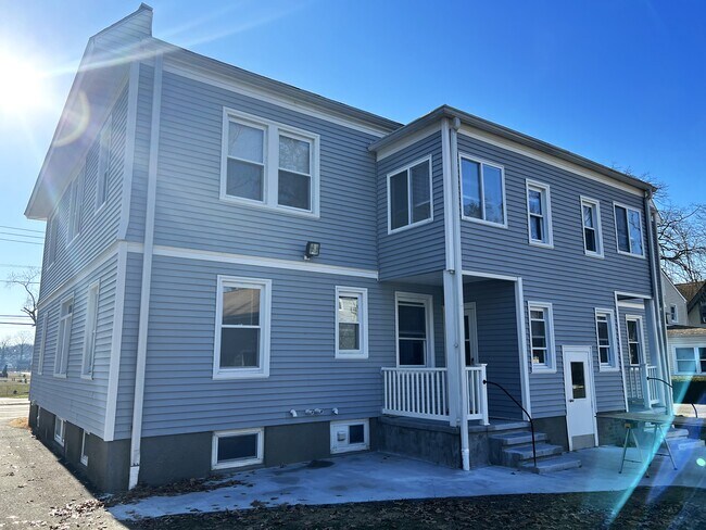 Back view of building, on site parking off street. - 84 Cherry St