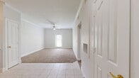 Located at 5950 Antoine Dr in Houston, TX, this one-bedroom, one-bathroom unit offers a practical and well-organized single-floor layout. The kitchen is a standout feature, showcasing rich warm-toned wood cabinetry, granite-look countertops, tile flooring, and a full suite of stainless steel appliances including a refrigerator, electric range, and dishwasher. Track lighting overhead and ample cabinet storage make this kitchen both functional and visually appealing. The bedroom is a comfortable, well-proportioned space finished with plush carpeting, crown molding, and a ceiling fan with integrated lighting. A window allows natural light to filter in, offering a view of the surrounding greenery. A double-door closet provides convenient storage. The bathroom is clean and straightforward, featuring tile flooring, a combination tub and shower with white tile surround, a wood vanity with granite-look countertop, and a large mirror. A hallway connects the rooms, contributing to an efficient flow throughout the unit. Neutral wall tones and consistent finishes throughout create a cohesive, move-in-ready atmosphere suited for comfortable everyday living.