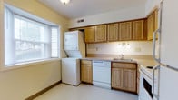 Located at 379 Rivermoor Dr in Marietta, Pennsylvania, this two-story home offers a practical and comfortable layout designed for everyday living. The kitchen is a standout feature, outfitted with warm honey-toned cabinetry that provides generous storage both above and below the countertops. A double sink, dishwasher, and ample counter space make the kitchen highly functional. A notable convenience is the stacked in-unit washer and dryer, tucked neatly alongside the kitchen cabinetry, streamlining household routines. Natural light filters into the kitchen through a bay-style window fitted with blinds, brightening the space with a soft, neutral tone complemented by light yellow walls and light-colored flooring throughout. Overhead lighting with a classic sconce fixture adds a warm ambiance. Spanning two floors, the home provides a well-organized separation of living and private spaces, making it well-suited for a variety of lifestyles. The overall interior presents a clean, move-in ready aesthetic with a traditional design sensibility that balances practicality with comfort. Situated in the charming borough of Marietta along the Susquehanna River, the property benefits from a serene, residential setting.