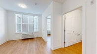 Located at 1001 W Elizabeth Ave in Linden, NJ, this one-bedroom, one-bathroom unit offers a thoughtfully designed layout across a single floor. Light-toned hardwood flooring runs throughout, lending a clean and cohesive feel to every room.

The combined dining and living area is bright and open, with large windows fitted with horizontal blinds that allow natural light to fill the space. A wall-mounted HVAC unit provides climate control, and clean white walls give the area a fresh, modern appearance.

The kitchen is well-appointed with gray shaker-style cabinetry, white subway tile backsplash, light countertops, and a full suite of stainless steel appliances, including a refrigerator, electric range, built-in microwave, and dishwasher.

The bedroom is a comfortable, private retreat with soft gray walls, a large window with natural light, an additional wall HVAC unit, and a double-door closet providing generous storage. Two additional closets are found throughout the unit, offering ample organization space.

The bathroom features wood-look flooring, a frameless glass walk-in shower with tile surround, a gray vanity with a light countertop, and clean white walls. An in-unit laundry area adds everyday convenience. Overall, the unit presents a modern, move-in-ready aesthetic.