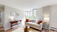 Located in Chicago's desirable Gold Coast neighborhood, this one-bedroom, one-bathroom residence at 55 West Chestnut Street offers a well-designed layout that maximizes functionality and comfort. The open-plan living and dining area is anchored by warm hardwood flooring and bathed in natural light through large corner windows that frame lush outdoor views, creating an airy and inviting atmosphere. The living space comfortably accommodates both a seating area and a dedicated dining zone, providing versatile use of the room.

The kitchen features an L-shaped layout with white cabinetry, dark countertops, and tile flooring. It is equipped with a full suite of appliances including a refrigerator, range, and sink, offering ample storage and counter space for everyday cooking.

The bedroom is a calm and comfortable retreat, finished with the same hardwood flooring found throughout the unit. A large window admits generous natural light, while two closets provide practical storage solutions.

The bathroom is finished with neutral beige tile throughout and includes a vanity with dark cabinetry, a toilet, and a full shower-tub combination. The clean, classic finishes lend a timeless quality to the space. Overall, this residence offers a cohesive and functional living environment in a prime Chicago location.