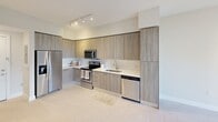 This 650 square foot apartment in Palmetto Bay, FL, offers a thoughtful blend of comfort and efficiency. The single-floor layout comprises one bedroom, one bathroom, and an open-concept living area. The primary bedroom, measuring 170 square feet, provides ample space for rest and relaxation.

The kitchen is a standout feature, boasting modern wood-grain cabinetry, stainless steel appliances, and a sleek countertop. It's equipped with a built-in microwave, electric range, and dishwasher, making meal preparation and cleanup a breeze. The light-colored backsplash and under-cabinet lighting enhance the bright, airy feel of the space.

Throughout the apartment, neutral tones dominate, creating a calm and versatile backdrop. Large windows in the bedroom allow natural light to flood in, while carpeting adds warmth underfoot. The bathroom and kitchen feature easy-to-clean tile flooring.

A hallway connects the various spaces, and a closet provides additional storage. The apartment's design maximizes the use of space, making it feel larger than its actual square footage. With its modern amenities and efficient layout, this apartment offers comfortable city living in a desirable Florida location.