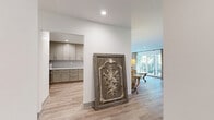 Located at 1408 Barry Ave in the desirable West Los Angeles neighborhood of 90025, this well-appointed 2-bedroom, 2-bathroom single-story home offers a thoughtfully designed layout with modern finishes throughout. Light oak hardwood-style flooring flows seamlessly across the entire space, creating a warm, cohesive aesthetic.

The living room serves as the centerpiece of the home, featuring a striking geometric-tiled fireplace wall that adds a bold architectural statement. Sliding glass doors open to an outdoor area, filling the room with natural light and providing a seamless indoor-outdoor connection.

The kitchen is outfitted with sage-toned shaker cabinetry, white quartz countertops, a subway tile backsplash, and stainless steel appliances, including a gas range and French door refrigerator — a functional and elegant space for cooking.

Both bedrooms are bright and well-proportioned. The primary bedroom benefits from large windows overlooking lush greenery, flooding the room with natural light. The second bedroom includes mirrored sliding closet doors for added storage.

Each bathroom is finished to a high standard. One features a glass-enclosed shower with subway tile surround and a marble-top vanity. The second bathroom also includes an in-unit stacked washer and dryer — a practical convenience. Hallways connecting the rooms are clean and uncluttered, reinforcing the home's modern sensibility.