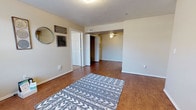Located at 18001 Highland Park Rd in Oklahoma City, Oklahoma, this single-floor residence offers a well-organized and functional layout across its living spaces. The main living area greets visitors with warm wood-look flooring, neutral-toned walls, and a textured ceiling. A front entry features a window that allows natural light to fill the space, complemented by ceiling fans that promote comfortable airflow throughout.

The kitchen is efficiently designed with light oak cabinetry, white countertops, and wood-look flooring that continues the cohesive aesthetic of the home. It is equipped with a black electric range, an over-the-range ventilation hood, and a full-size refrigerator, providing all the essentials for everyday cooking.

The bedroom is carpeted for comfort and includes a ceiling fan with lighting, as well as a window with blinds that admits natural light and outdoor views. Two bathrooms serve the unit — one featuring a tub-shower combination, and the other offering a vanity with oak cabinetry, an integrated sink, and a large mirror.

A dedicated in-unit laundry closet with washer and dryer hookups and built-in shelving adds convenience. The overall ambiance of the space is practical and inviting, with consistent finishes and a straightforward floor plan suited for comfortable everyday living.