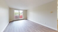 Located at 25 Lorne Avenue in Newmarket, Ontario, this thoughtfully updated 2-bedroom, 1-bathroom unit offers a clean, modern aesthetic throughout. Light-toned luxury vinyl plank flooring runs seamlessly across the entire space, complemented by soft neutral wall tones and crisp white trim and doors, creating a bright and cohesive feel.

The entrance leads into a well-organized layout that includes a living room, kitchen, two bedrooms, and a full bathroom. The living room is comfortably sized with a large sliding glass door that opens to a balcony, offering views of the surrounding Newmarket neighbourhood and allowing generous natural light to fill the space.

The galley-style kitchen is efficiently designed with white shaker cabinetry, white quartz countertops, a subway tile backsplash, and stainless steel appliances including a refrigerator, electric range, and over-the-range microwave. A window at the end of the kitchen adds additional natural light.

The primary bedroom is a comfortable size featuring a built-in sliding door closet and access to adjacent spaces. The second bedroom also includes a window with neighbourhood views and baseboard heating. Both rooms maintain the consistent neutral palette found throughout the unit.

The bathroom is finished in white with a full soaker tub and shower, a white vanity with ample counter space, and wood-toned flooring that ties the space together cleanly.