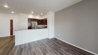 Located at 4826 Van Buren Blvd in Riverside, California, this single-floor unit offers a well-appointed, modern interior designed for comfortable everyday living. The open-concept layout seamlessly connects the kitchen and living area, creating a spacious and functional flow throughout the main living space. Rich hardwood-style flooring extends across the kitchen and living areas, adding warmth and a contemporary aesthetic.

The kitchen is a standout feature, showcasing deep espresso-toned cabinetry with sleek hardware, granite countertops, and a full suite of stainless steel appliances including a gas range, over-the-range microwave, refrigerator, and dishwasher. A peninsula counter provides additional prep space and separates the kitchen from the living area. A sliding glass door in the living room allows natural light to fill the space and provides outdoor access.

The bedroom offers a calm retreat, finished with plush carpeting and a window fitted with horizontal blinds that allow for adjustable natural light. The bathroom is clean and functional, featuring matching espresso cabinetry, a granite-topped vanity with a large mirror, hardwood-style flooring, and a shower-tub combination. Recessed lighting throughout the unit contributes to a bright and inviting atmosphere.