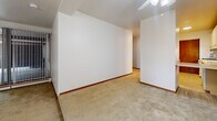Located at 5634 W Oklahoma Ave in Milwaukee, Wisconsin, this single-floor, two-bedroom, one-bathroom residence offers a straightforward and functional layout. The interior is finished with neutral-toned carpeting throughout, warm wood baseboards, and clean white walls that create a bright, understated aesthetic.

The generously sized primary bedroom is one of the standout features of this unit, offering an expansive area with ample room for furnishings. It is equipped with a ceiling fan and benefits from natural light through a window dressed with vertical blinds. Baseboard heating runs along the perimeter, ensuring consistent warmth. The second bedroom mirrors a similar design — carpeted and well-proportioned, with its own window featuring vertical blinds and baseboard heating.

Storage is well addressed with a dedicated walk-in closet, featuring multi-tiered shelving along the walls and soft carpeted flooring, providing practical organization space.

The bathroom is cleanly appointed with a full-size soaking tub and shower combination, surrounded by cream-colored ceramic tile. A white toilet and classic chrome and gold fixtures complete the space.

The overall floor plan, as reflected in the 3D model, presents a compact yet efficient arrangement of rooms, making this a practical and comfortable residence in a residential Milwaukee neighborhood.