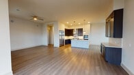 This thoughtfully designed single-floor residence offers a seamless blend of contemporary style and functional living. The open-concept layout connects the living area to a well-appointed kitchen, which serves as the heart of the home. The kitchen features rich dark cabinetry, stainless steel appliances including a built-in double wall oven and a full-size refrigerator, a gas cooktop with a sleek range hood, and a light-toned island with an integrated sink accented by stylish globe pendant lighting. Wood-look flooring flows throughout the main living areas, complemented by recessed lighting and a ceiling fan for year-round comfort.

The primary bathroom is a standout feature, finished in elegant marble-look tile from floor to ceiling. It includes a freestanding soaking tub, a glass-enclosed walk-in shower, dual vanity sinks set in dark cabinetry, and a large LED-backlit mirror that adds a modern, spa-like ambiance. A secondary bathroom mirrors this refined aesthetic with marble tile, a dark vanity, and a glass shower enclosure.

The bedrooms are generously proportioned with neutral tones and wood-look flooring, offering a calm and versatile environment. The primary bedroom connects to a spacious walk-in closet outfitted with a full custom shelving and drawer system, providing extensive organized storage. Additional rooms offer flexible use as bedrooms or home office spaces.