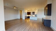 This thoughtfully designed single-floor residence offers a seamless blend of contemporary style and functional living. The open-concept layout connects the living area to a well-appointed kitchen, which serves as the heart of the home. The kitchen features rich dark cabinetry, stainless steel appliances including a built-in double wall oven and a full-size refrigerator, a gas cooktop with a sleek range hood, and a light-toned island with an integrated sink accented by stylish globe pendant lighting. Wood-look flooring flows throughout the main living areas, complemented by recessed lighting and a ceiling fan for year-round comfort.

The primary bathroom is a standout feature, finished in elegant marble-look tile from floor to ceiling. It includes a freestanding soaking tub, a glass-enclosed walk-in shower, dual vanity sinks set in dark cabinetry, and a large LED-backlit mirror that adds a modern, spa-like ambiance. A secondary bathroom mirrors this refined aesthetic with marble tile, a dark vanity, and a glass shower enclosure.

The bedrooms are generously proportioned with neutral tones and wood-look flooring, offering a calm and versatile environment. The primary bedroom connects to a spacious walk-in closet outfitted with a full custom shelving and drawer system, providing extensive organized storage. Additional rooms offer flexible use as bedrooms or home office spaces.