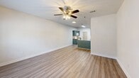Located at 11350 New Orleans Ave in Gulfport, Mississippi, this single-story home offers three bedrooms, two bathrooms, and a practical, well-organized layout. The open-concept living and kitchen area forms the heart of the home, with light wood-style flooring and a ceiling fan creating a bright, airy atmosphere. Large windows in the living room allow natural light to fill the space and offer views of the surrounding neighborhood.

The kitchen is well-appointed with distinctive teal-painted cabinetry, granite-look countertops, a peninsula with additional storage and counter space, a double stainless steel sink, and white appliances including a range and refrigerator. The kitchen flows seamlessly into the living area, making it ideal for everyday living and entertaining.

Each of the three bedrooms features light wood-style flooring, ceiling fans with light fixtures, and closets with panel doors. The spacious primary bedroom offers direct access to one of the two bathrooms, providing added convenience. The secondary bedrooms are well-proportioned, with at least one featuring a window with natural light.

Both bathrooms are consistently finished with teal cabinetry, granite-look countertops, single-basin sinks, mirrors, and tub/shower combinations. Hallways connect the rooms efficiently, contributing to the home's functional and cohesive single-floor design.