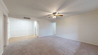 Located in Austin, TX 78753, this single-story, 3-bedroom, 2-bathroom home offers a practical and comfortable layout across a well-utilized floor plan. The living area welcomes you with plush carpeting, crown molding, and a ceiling fan with integrated lighting, creating a bright and airy atmosphere. A large window allows natural light to fill the space and offers pleasant outdoor views, while a front entry door provides convenient access. The interior transitions seamlessly between rooms, with hardwood-style flooring featured in the hallways and kitchen areas, adding warmth and durability underfoot. The kitchen is efficiently designed, featuring light granite-style countertops, white cabinetry, a gas range, and a dishwasher — all finished in a clean, cohesive white palette. The generously sized primary bedroom offers ample room and its own ceiling fan, while the two additional bedrooms each feature carpet, ceiling fans, and windows that bring in natural light. Two closets provide dedicated storage throughout the home. Both bathrooms are finished with classic white tile tub-shower combinations, chrome fixtures, and a clean, timeless aesthetic. Crown molding is a consistent detail found throughout the home, lending a polished finish to every room.