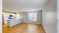 Located at 6400 Preserve Crossing Blvd N in Gahanna, Ohio, this single-floor, 2-bedroom, 2-bathroom home offers a thoughtfully designed layout with modern finishes throughout. The open-concept living and kitchen area forms the heart of the home, featuring light hardwood flooring, soft neutral wall tones, and natural light streaming in through slatted blinds. The kitchen is equipped with stainless steel appliances, including a refrigerator and electric range, white shaker cabinetry with gold hardware, a subway tile backsplash, and a generous peninsula with a white countertop and built-in sink — ideal for both cooking and casual dining. The living area flows seamlessly from the kitchen, offering an open and airy feel. The spacious primary bedroom features light hardwood flooring and dual windows that bring in ample natural light, while the second bedroom is finished with plush carpet and a bright window with outdoor views. Both bathrooms are clean and functional, with white vanities and matching hardwood flooring. Two closets, including a walk-in with wire shelving, provide practical storage. The clean, contemporary aesthetic is consistent throughout, making this a comfortable and move-in-ready home.