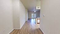 This well-designed two-bedroom, two-bathroom home in Amarillo, Texas offers a comfortable and functional single-floor layout. The entrance leads into a long, open corridor that flows naturally into the combined kitchen and living area, creating a seamless and airy feel throughout. Light wood-toned luxury vinyl plank flooring spans the entirety of the home, lending a clean, modern aesthetic.

The living room is generously proportioned, featuring a ceiling fan and a set of French doors that provide access to the outdoors while filling the space with natural light. The kitchen is efficiently laid out with white cabinetry accented by warm wood trim, dark countertops, a gas range, built-in microwave, and a dishwasher. A pantry provides additional storage, and the adjacent laundry area adds everyday convenience.

Both bedrooms are well-sized, with the primary bedroom offering ample space and its own closet. Each bedroom benefits from large windows fitted with blinds, allowing for controlled natural light and views of the surrounding neighborhood. The two bathrooms are distinctly configured — one includes a tub-shower combination, while the other features a walk-in glass shower — both with vanities accented by wood-trimmed cabinetry and large mirrors. Three closets throughout the home ensure plentiful storage for all residents.