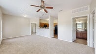 Located at 1712 Martin Dr in Weatherford, TX, this single-story home features a practical and comfortable layout across two bedrooms and two full bathrooms. The open-concept living area is bright and welcoming, with large windows that invite natural light and ceiling fans overhead for year-round comfort. Soft neutral carpeting flows throughout the living and bedroom spaces, creating a warm, cohesive aesthetic.

The kitchen is well-appointed with warm wood cabinetry, dark granite-style countertops, and black appliances including a range, built-in microwave, and dishwasher. It connects seamlessly to the living area via a half-wall counter, enhancing the open flow of the home.

Both bedrooms are generously proportioned, each featuring plush carpet, ceiling fans, and easy access to dedicated closets. The spacious primary bedroom offers ample room for a full furniture arrangement. Each bathroom includes a full tub-shower combination with clean tile surrounds and wood-toned cabinetry for storage.

Additional highlights include a dedicated laundry room and a neutral color palette throughout that provides a versatile backdrop for any décor style. The overall layout is efficient and thoughtfully designed, making this home a comfortable and practical residence in Weatherford, TX.
