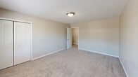 Located at 804 N Tibbs Rd in Dalton, Georgia, this two-story home offers two bedrooms and two bathrooms across a thoughtfully laid-out floor plan. The main level provides the larger portion of the living space and includes a kitchen equipped with white shaker-style cabinetry, a subway tile backsplash, marble-look countertops, black appliances including a range, dishwasher, and refrigerator, and durable wood-look flooring. Natural light filters in through multiple windows, including those flanking the exterior door. The upper level houses the bedrooms, each featuring neutral tones and carpet flooring. The spacious primary bedroom includes a closet and a window overlooking the surrounding area. The second bedroom features the same wood-look flooring found on the main level, offering a clean and cohesive aesthetic. Both bathrooms are finished with wood-look flooring, white vanities, and bright lighting. One bathroom features a full tub-shower combination, while the other includes a vanity with a mirror and stylish light fixture. Connecting the floors is a staircase visible in the structural overview of the home. The overall interior maintains a clean, neutral palette throughout, creating a bright and move-in ready atmosphere.