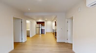 Located at 6914 NE 126th St in Vancouver, WA, this well-designed 2-bedroom, 1-bathroom single-floor home offers a clean, contemporary aesthetic throughout. Light wood-tone flooring flows seamlessly across the entire space, complementing the crisp white walls and recessed lighting that create a bright, welcoming ambiance.

The open-concept living, dining, and kitchen area serves as the heart of the home. The kitchen is a standout feature, boasting rich walnut-toned cabinetry, a white subway tile backsplash, white quartz countertops, a stainless steel refrigerator, range, microwave, and dishwasher — all designed for both functionality and style.

The primary bedroom is a comfortable, well-proportioned retreat, while the second bedroom features a window with views of the surrounding community. A dedicated den provides flexible space for a home office or additional living area. The full bathroom is finished with a grey vanity, white countertop, and a tub/shower combo, while a second bathroom space offers a standalone shower and vanity.

Three closets, including a spacious walk-in with wire shelving, provide ample storage. A dedicated laundry area and a patio round out the practical features of this thoughtfully laid-out home.