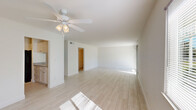 Located at 1025 S Beach St in Daytona Beach, FL, this single-floor, 2-bedroom, 2-bathroom home offers a clean, bright, and functional layout. Light-toned wood-look tile flooring runs throughout, creating a cohesive and airy feel across every room.

The combined living and dining area is generously sized, bathed in natural light from a large sliding glass door, and equipped with a ceiling fan. The open feel is enhanced by crisp white walls and seamless flow into the kitchen and hallway beyond.

The kitchen features white shaker-style cabinetry, granite-look countertops, black appliances including a range and refrigerator, and a range hood — all set against the same light flooring for a clean, modern look.

Both bedrooms are well-proportioned and filled with natural light from windows. The spacious primary bedroom includes a closet, while the second bedroom features a sliding closet with paneled doors. The home also includes three closets in total, providing ample storage.

Each bathroom is outfitted with a tub/shower combo, white tile surround, and chrome fixtures, maintaining the home's clean, neutral aesthetic. The entrance and hallway connect the spaces efficiently, contributing to the home's practical and organized flow.