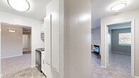 Located at 2215 Montauk Rd NW in Roanoke, Virginia, this single-floor, 2-bedroom, 3-bathroom home offers a practical and well-appointed layout. The open combined living and dining area is a standout feature, anchored by a classic fireplace with a white mantle and finished with soft, neutral-toned carpeting throughout. A pendant light fixture defines the dining area, which flows seamlessly into the living space, creating a welcoming and versatile environment.

The kitchen is outfitted with white shaker-style cabinetry, marble-look countertops, and black electric range with an over-the-range stainless steel microwave, offering both style and functionality. Tile flooring adds durability to this workspace.

Both bedrooms are carpeted and feature windows with blinds that invite natural light and outdoor views. The primary bedroom provides a comfortable footprint with ample room for furnishings. Four closets throughout the home offer abundant storage options.

The three bathrooms include at least one full bath featuring tile flooring, a white vanity with brushed nickel hardware, a lighted mirror, and a tub/shower combination. An additional water closet provides added convenience.

The home also includes a den, a hallway, and a balcony, rounding out a complete and functional living space suited for everyday comfort.