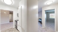 Located at 2215 Montauk Rd NW in Roanoke, Virginia, this single-floor, 2-bedroom, 3-bathroom home offers a practical and well-appointed layout. The open combined living and dining area is a standout feature, anchored by a classic fireplace with a white mantle and finished with soft, neutral-toned carpeting throughout. A pendant light fixture defines the dining area, which flows seamlessly into the living space, creating a welcoming and versatile environment.

The kitchen is outfitted with white shaker-style cabinetry, marble-look countertops, and black electric range with an over-the-range stainless steel microwave, offering both style and functionality. Tile flooring adds durability to this workspace.

Both bedrooms are carpeted and feature windows with blinds that invite natural light and outdoor views. The primary bedroom provides a comfortable footprint with ample room for furnishings. Four closets throughout the home offer abundant storage options.

The three bathrooms include at least one full bath featuring tile flooring, a white vanity with brushed nickel hardware, a lighted mirror, and a tub/shower combination. An additional water closet provides added convenience.

The home also includes a den, a hallway, and a balcony, rounding out a complete and functional living space suited for everyday comfort.