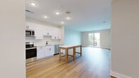 Located at 7220 Midlothian Turnpike in Richmond, VA, this well-appointed 1-bedroom, 1-bathroom unit offers a thoughtfully designed layout across a single floor. The open-concept kitchen and living area serves as the heart of the home, featuring light luxury vinyl plank flooring, recessed lighting, and sliding glass doors that open onto a private balcony with pleasant outdoor views. The kitchen is outfitted with crisp white shaker cabinetry, a classic subway tile backsplash, stainless steel appliances including a range, microwave, dishwasher, and refrigerator, and a single-basin sink with a modern faucet. A pantry provides additional storage, complementing the generous cabinet space. The bedroom is carpeted for comfort, filled with natural light from windows with blinds, and includes a ceiling fan. Two closets offer ample storage throughout the unit. The bathroom features a white vanity with a clean countertop, black hardware accents, and a tub/shower combination with tile surround. Additional conveniences include a dedicated laundry area and utility room. Neutral tones and modern finishes throughout create a bright, clean, and move-in-ready living environment.