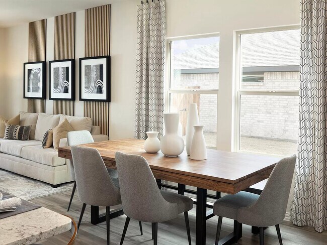 Enjoy family dinners around the dining table. - 1509 Wind Springs Dr