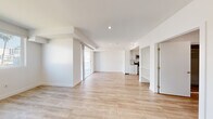 Located at 744 Hartford Ave in Los Angeles, CA, this well-designed one-bedroom residence offers a clean, modern aesthetic with a thoughtful layout across a single floor. Light wood-style flooring flows seamlessly throughout the entire unit, contributing to a bright and cohesive feel.

The open living area is spacious and filled with natural light, thanks to a sliding glass door that leads to a private balcony with city views. The space is versatile and well-proportioned, providing room for comfortable living and dining arrangements.

The galley-style kitchen is efficiently designed and features white cabinetry with modern hardware, a classic white subway tile backsplash, light-toned countertops, and a full suite of stainless steel appliances including a gas range, over-the-range microwave, dishwasher, and sink. Recessed lighting and a ceiling-mounted ventilation panel keep the kitchen functional and polished.

The bedroom is generously sized, accommodating a comfortable furniture arrangement. It includes a mirrored sliding-door closet for ample storage and a ceiling fan with a recessed light. A window brings in natural light and city views, enhancing the room's airy atmosphere.

Throughout the unit, crisp white walls, recessed lighting, and clean architectural lines create a contemporary and inviting living environment.