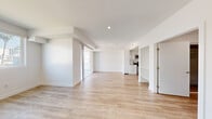 Located at 744 Hartford Ave in Los Angeles, CA, this well-designed one-bedroom residence offers a clean, modern aesthetic with a thoughtful layout across a single floor. Light wood-style flooring flows seamlessly throughout the entire unit, contributing to a bright and cohesive feel.

The open living area is spacious and filled with natural light, thanks to a sliding glass door that leads to a private balcony with city views. The space is versatile and well-proportioned, providing room for comfortable living and dining arrangements.

The galley-style kitchen is efficiently designed and features white cabinetry with modern hardware, a classic white subway tile backsplash, light-toned countertops, and a full suite of stainless steel appliances including a gas range, over-the-range microwave, dishwasher, and sink. Recessed lighting and a ceiling-mounted ventilation panel keep the kitchen functional and polished.

The bedroom is generously sized, accommodating a comfortable furniture arrangement. It includes a mirrored sliding-door closet for ample storage and a ceiling fan with a recessed light. A window brings in natural light and city views, enhancing the room's airy atmosphere.

Throughout the unit, crisp white walls, recessed lighting, and clean architectural lines create a contemporary and inviting living environment.