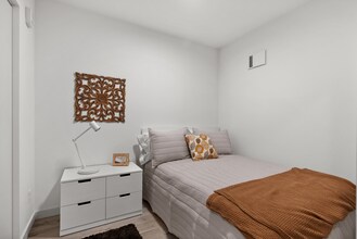 Comfortable secondary bedroom with a clean, modern design. - The Ruby Apartments