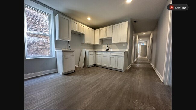 Newly renovated kitchen with white shaker cabinets, new countertops, and stainless steel appliances - 5653 S May St