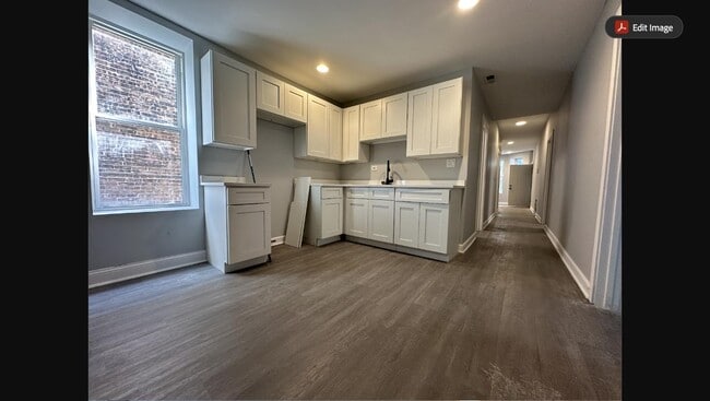Newly renovated kitchen with white shaker cabinets, new countertops, and stainless steel appliances - 5653 S May St