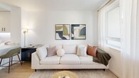 This contemporary 550 square foot apartment in Santa Cruz offers a thoughtfully designed living space. The open-concept floor plan combines the kitchen, living, and dining areas, creating a spacious feel despite the compact footprint. The kitchen boasts sleek white cabinetry, stainless steel appliances, and under-cabinet lighting, perfect for culinary enthusiasts.

The living room is bathed in natural light from large windows and features a glass door leading to a private balcony, offering urban views. A neutral color palette and light wood flooring throughout enhance the apartment's bright, airy ambiance. The bedroom, measuring 140 square feet, provides a cozy retreat with ample space for a queen-sized bed and includes a dedicated work area near the window.

The bathroom showcases a modern design with a white vanity, large mirror, and a combination tub-shower. Throughout the apartment, clever storage solutions and minimalist decor maximize the available space. Located at 414 Front St in Santa Cruz, this apartment combines style and functionality, making it an ideal home for those seeking a contemporary urban lifestyle.