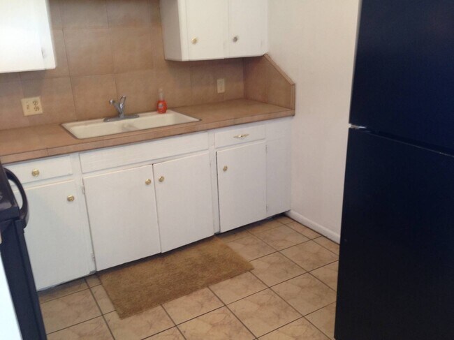 Lots of cabinet space, tiled backsplash, microwave included but not shown. - 2319 Leaman Ave
