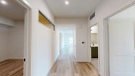Located at 800 N Front St in Burbank, CA, this well-appointed 3-bedroom, 3-bathroom residence offers a thoughtfully designed single-level layout with generous living space. Light wood plank flooring flows seamlessly throughout, complementing the clean, modern aesthetic defined by crisp white walls and recessed lighting.

The open-concept kitchen and living area serves as the heart of the home, featuring sage-green lower cabinetry paired with light upper cabinets, a classic subway tile backsplash, stainless steel appliances, and a central island with a white countertop — ideal for dining and entertaining. Pendant lighting and a large window bring in abundant natural light, with views of the surrounding neighborhood.

The spacious living room offers direct access to a private balcony, extending the living space outdoors. Each of the three bedrooms is bright and airy, with large windows framing green outdoor views and light pouring across the wood floors. The bedrooms are well-served by four closets, including walk-in options with built-in shelving and hanging rods.

All three bathrooms feature tiled tub-shower combinations with matte black fixtures, built-in shelving niches, and tile flooring. A dedicated laundry area and a central hallway connecting all rooms add to the home's practical functionality.