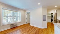 Located at 70 Polifly Rd in Hackensack, NJ, this well-appointed one-bedroom unit offers a thoughtfully designed layout across a single floor. Warm hardwood flooring and crisp crown molding are consistent throughout, creating a cohesive and polished aesthetic.

The open-concept kitchen and living area serves as the heart of the unit. The kitchen is outfitted with white shaker cabinetry, a subway tile backsplash, granite countertops, stainless steel appliances, and a peninsula that provides both additional prep space and a natural divide between cooking and living areas. Recessed lighting and a ceiling fan enhance comfort and functionality in the combined living space.

The bedroom is a well-proportioned, private retreat featuring a large window that invites natural light and an in-wall HVAC unit. Crown molding and hardwood floors continue here, maintaining a consistent finish throughout. An exceptionally spacious walk-in closet adjoins the bedroom, outfitted with a full wall-to-wall built-in shelving and hanging system, offering abundant storage options.

A dedicated laundry area houses a stacked washer and dryer unit alongside additional shelving. The unit's neutral color palette, clean lines, and quality finishes make it a practical and attractive living space in a convenient Hackensack location.
