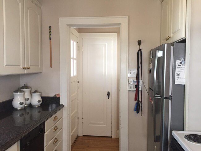 Kitchen leading to back porch. - 1347 W Highland Pkwy