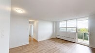 Located on the 8th floor at 100 Dundas St E in Mississauga, this well-appointed three-bedroom, one-bathroom unit offers a clean, modern aesthetic throughout. Light wood laminate flooring runs continuously across all rooms, creating a warm and cohesive feel. Crisp white walls and abundant natural light from multiple windows contribute to a bright, airy atmosphere.

The kitchen is a standout feature, outfitted with white shaker-style cabinetry, a white subway tile backsplash, stone-look countertops, and stainless steel appliances including an LG French-door refrigerator and dishwasher. The living room connects openly to the kitchen, offering a functional layout for everyday living. A large window in the primary bedroom frames urban views of the surrounding Mississauga cityscape, while baseboard heating units run along the exterior walls throughout.

Each of the three bedrooms is finished consistently with light flooring and white walls, providing versatile, move-in ready spaces. The primary bedroom offers a generous footprint with a dedicated window view. The full bathroom features floor-to-ceiling white subway tile, a soaker tub, and a chrome handheld showerhead, delivering a clean, timeless look. A hallway connects the rooms efficiently, completing this practical and well-maintained unit.