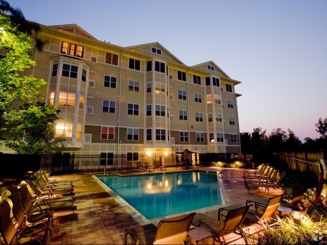 Exterior View of Pool and Apartments at Night - Canton Woods