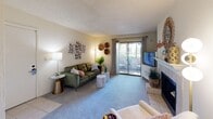 This efficient and thoughtfully designed one-bedroom, one-bathroom residence offers a comfortable single-floor layout that maximizes every square foot. The living room serves as the welcoming heart of the home, featuring plush carpet, a cozy fireplace, and a sliding glass door that opens to a private outdoor balcony, allowing for natural light and outdoor views. Tile flooring transitions seamlessly near the entryway and kitchen area.

The galley-style kitchen is well-equipped, featuring rich dark-wood cabinetry, granite-style countertops, a double-basin stainless steel sink, and black appliances including a refrigerator, electric range, microwave, and dishwasher. An adjacent dining area provides an intimate space for meals, with room for a small table and chairs.

The bedroom is a quiet retreat finished with soft carpet, a natural window bringing in ample daylight, a textured ceiling, and access to a spacious walk-in closet. The full bathroom includes a single-sink vanity with generous counter space, dark-wood cabinetry, a large wall mirror, and a shower-tub combination. A washer unit is also visible within the unit, adding everyday convenience throughout this practical and inviting home.