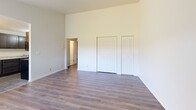 Located at 6867 York Rd in Parma Heights, Ohio, this two-bedroom, one-bathroom single-floor home offers a practical and well-appointed layout. The living room greets you with a tiled entryway that transitions into warm hardwood-style laminate flooring, a front door with a fan-lite window, and a wall-mounted AC unit beneath a large window that fills the space with natural light. Vaulted ceilings in the living area lend an airy, open feel that enhances the sense of space throughout.

The combined dining room and kitchen is a functional highlight, featuring dark espresso cabinetry, light granite countertops, tile flooring, and a chandelier overhead. A large window with vertical blinds brings in additional natural light, making the space bright and inviting.

Both bedrooms are finished with hardwood-style laminate flooring and include closets with bi-fold doors. The primary bedroom benefits from elevated vaulted ceilings, while the second bedroom features a ceiling fan and a window overlooking the outdoors. Three closets total provide ample storage throughout the home.

The bathroom is finished with neutral tile flooring, a tiled tub-shower surround, a single vanity with a mirrored medicine cabinet, and classic fixtures. A connecting hallway ties all rooms together for a cohesive and efficient floor plan.