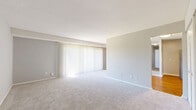 Located at 201 Idlewild Rd in Bel Air, Maryland, this 2-bedroom, 3-bathroom residence offers a practical and comfortable single-floor layout. The kitchen is well-appointed with white shaker-style cabinetry, granite countertops, a subway tile backsplash, and a full suite of stainless steel appliances including a range, microwave, and dishwasher. A peninsula with additional granite countertop space and white cabinetry below extends into the living area, which features warm hardwood flooring and a ceiling fan. Large sliding glass doors flood the living space with natural light and provide views of the surrounding greenery. The spacious primary bedroom is carpeted and includes an expansive double closet, a ceiling fan, and direct access to the kitchen area. The second bedroom also features soft carpeting, a built-in closet, and a window that brings in natural light. All three bathrooms maintain a cohesive design with granite-topped white vanities, hardwood flooring, and clean white finishes. One bathroom features a tiled tub-shower combination. Neutral gray walls and white trim throughout create a clean, move-in-ready aesthetic across the entire residence.