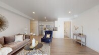 This thoughtfully designed single-floor residence offers a seamless open-concept layout that connects the living, dining, and kitchen areas into one cohesive and functional space. Light wood-tone flooring flows throughout, lending warmth and continuity to every room.

The spacious living area is bright and airy, illuminated by recessed lighting and generous natural light. It provides ample room for comfortable seating arrangements and transitions naturally into a dedicated dining nook featuring a large window that fills the space with sunlight.

The kitchen is a standout feature, outfitted with crisp white shaker cabinetry, dark granite countertops, a classic subway tile backsplash, and a full suite of stainless steel appliances including a refrigerator, range, microwave, and dishwasher. A peninsula provides additional prep space and casual seating.

The bedrooms are serene and well-proportioned, each with clean white walls, closet storage, and windows that invite natural light. The bathroom is finished with large-format marble-look tile surround on the soaking tub and shower, complemented by wood-look tile flooring, creating a clean and refined aesthetic throughout. The overall ambiance of the space is modern, bright, and inviting.