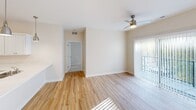This contemporary apartment offers a thoughtfully designed living space of 980 square feet. The open-concept floor plan seamlessly integrates the kitchen and living room, creating an expansive feel. The kitchen is a highlight, featuring crisp white cabinetry, ample counter space, and a suite of stainless steel appliances including a refrigerator, stove, and built-in microwave.

The apartment boasts two bedrooms, with the primary bedroom measuring a spacious 170 square feet. Both bedrooms are carpeted for comfort and feature closets with wire shelving systems for organization. The two bathrooms are well-appointed, with one showcasing hardwood flooring and a modern vanity.

Throughout the apartment, hardwood floors add warmth and elegance to the living areas. Large windows and sliding glass doors allow natural light to flood the space, while modern ceiling fans provide both illumination and air circulation. The neutral color palette creates a blank canvas for personal style.

Additional amenities include recessed lighting, a dedicated closet space, and a hallway connecting the various rooms. The overall ambiance is one of contemporary comfort, making this apartment an ideal urban dwelling in Cedar Rapids.