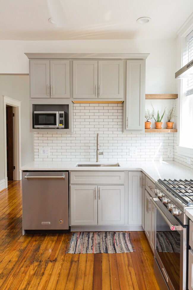 Updated kitchen with quartz countertops. - 3636 Commonwealth Ave