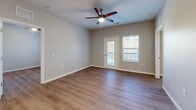 Located at 2747 Kelly Lake Rd in Decatur, GA, this well-designed 2-bedroom, 2-bathroom residence offers a thoughtful single-floor layout with modern finishes throughout. The open-concept living area seamlessly connects the kitchen, dining, and living spaces, creating a bright and functional environment illuminated by recessed lighting. The kitchen is a standout feature, showcasing granite countertops, a center island with a built-in sink, dark espresso cabinetry, and a full suite of stainless steel appliances including a refrigerator, range, and microwave. Wood-look luxury vinyl plank flooring runs throughout the entire home, adding warmth and cohesion. Both bedrooms are well-proportioned, each equipped with a ceiling fan and natural light from windows with views of the outdoors. The primary bedroom offers a comfortable footprint with closet access. Both bathrooms mirror the home's design aesthetic, featuring granite-topped vanities with dark cabinetry and tub-shower combinations. Additional conveniences include a dedicated laundry area, utility room, and multiple closets for ample storage. The entrance provides a welcoming transition into this clean, contemporary home.