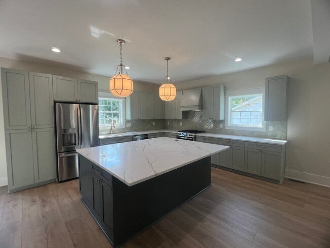 Gorgeous open kitchen with quartz countertops and an oversized island - 1250 S Madison Ave