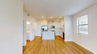 Located at 1905 Champs Dr. in Naples, FL, this well-appointed one-bedroom, one-bathroom unit offers a clean, modern aesthetic throughout its efficiently designed single-floor layout. Light wood-style flooring flows seamlessly across all rooms, complementing the bright white walls and creating a cohesive, contemporary feel.

The open-concept kitchen and living area serves as the heart of the unit. The kitchen is outfitted with white shaker-style cabinetry extending to the ceiling, a white subway tile backsplash, quartz countertops, a center island, and a full suite of stainless steel appliances including a refrigerator with ice maker, range, over-the-range microwave, and dishwasher. Recessed lighting adds to the clean, well-lit atmosphere. The adjacent living area features a large sliding glass door that fills the space with natural light and provides views of the surrounding greenery.

The bedroom is a comfortable, well-proportioned room with a ceiling fan, a window with blinds offering natural light, and access to a dedicated closet. The bathroom features a white vanity with ample cabinet storage, quartz countertop, a large mirror, and a full tub-shower combination with white tile surround and brushed nickel fixtures. The unit's consistent use of neutral tones and quality finishes throughout gives it a fresh, move-in-ready appeal.