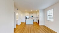 Located at 1905 Champs Dr. in Naples, FL, this well-appointed one-bedroom, one-bathroom unit offers a clean, modern aesthetic throughout its efficiently designed single-floor layout. Light wood-style flooring flows seamlessly across all rooms, complementing the bright white walls and creating a cohesive, contemporary feel.

The open-concept kitchen and living area serves as the heart of the unit. The kitchen is outfitted with white shaker-style cabinetry extending to the ceiling, a white subway tile backsplash, quartz countertops, a center island, and a full suite of stainless steel appliances including a refrigerator with ice maker, range, over-the-range microwave, and dishwasher. Recessed lighting adds to the clean, well-lit atmosphere. The adjacent living area features a large sliding glass door that fills the space with natural light and provides views of the surrounding greenery.

The bedroom is a comfortable, well-proportioned room with a ceiling fan, a window with blinds offering natural light, and access to a dedicated closet. The bathroom features a white vanity with ample cabinet storage, quartz countertop, a large mirror, and a full tub-shower combination with white tile surround and brushed nickel fixtures. The unit's consistent use of neutral tones and quality finishes throughout gives it a fresh, move-in-ready appeal.