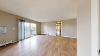 Located at 1620 Coronado Pkwy S in Denver, CO, this single-floor unit offers three bedrooms and two bathrooms with a functional, well-organized layout. The spacious living room is a standout feature, showcasing light wood-style flooring, neutral beige walls, and a textured ceiling. Baseboard heating runs throughout, and a wall-mounted AC unit provides year-round comfort. Sliding glass doors flood the living area with natural light and open directly onto a private patio with outdoor views. The kitchen features warm oak cabinetry, granite-style countertops, a double-basin sink, and black appliances, offering ample storage and prep space. A hallway connects the main living areas to the three carpeted bedrooms, each finished with neutral tones, textured ceilings, and natural light from windows. The bedrooms are well-served by an impressive five closets distributed throughout the unit. The two bathrooms include a full bath with a tiled tub surround with chrome fixtures, and a second bath with a wood-framed medicine cabinet mirror, vanity lighting, and a granite-style countertop. This unit offers a practical, comfortable living environment in a convenient Denver location.